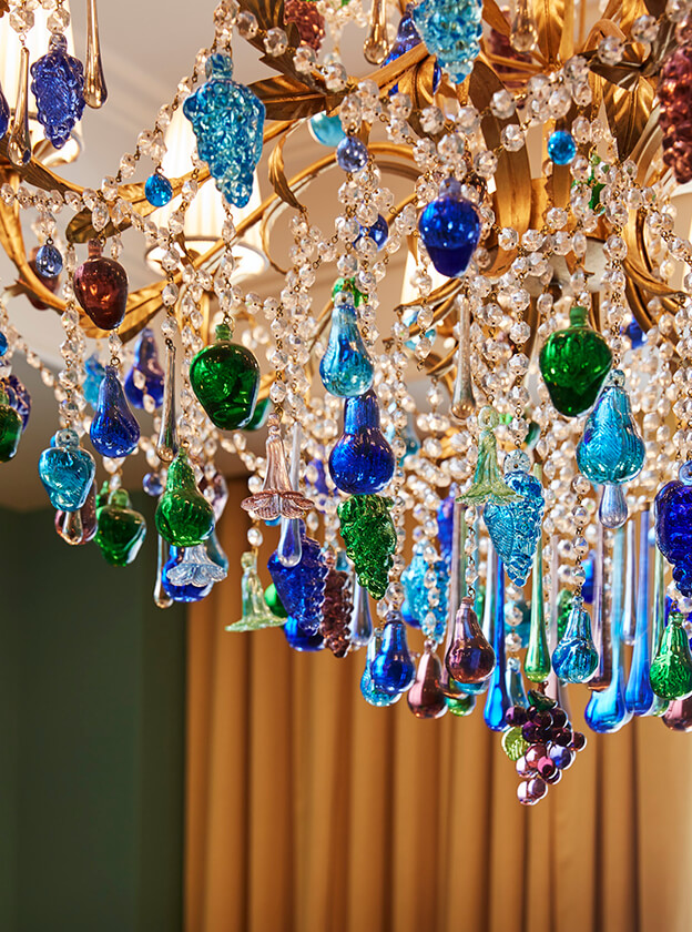 A graceful chandelier with crystal accents hangs elegantly from the ceiling, enhancing the atmosphere.