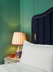 Handcrafted night lamp accompanied by delicately arranged sweet boxes on the bedside table.