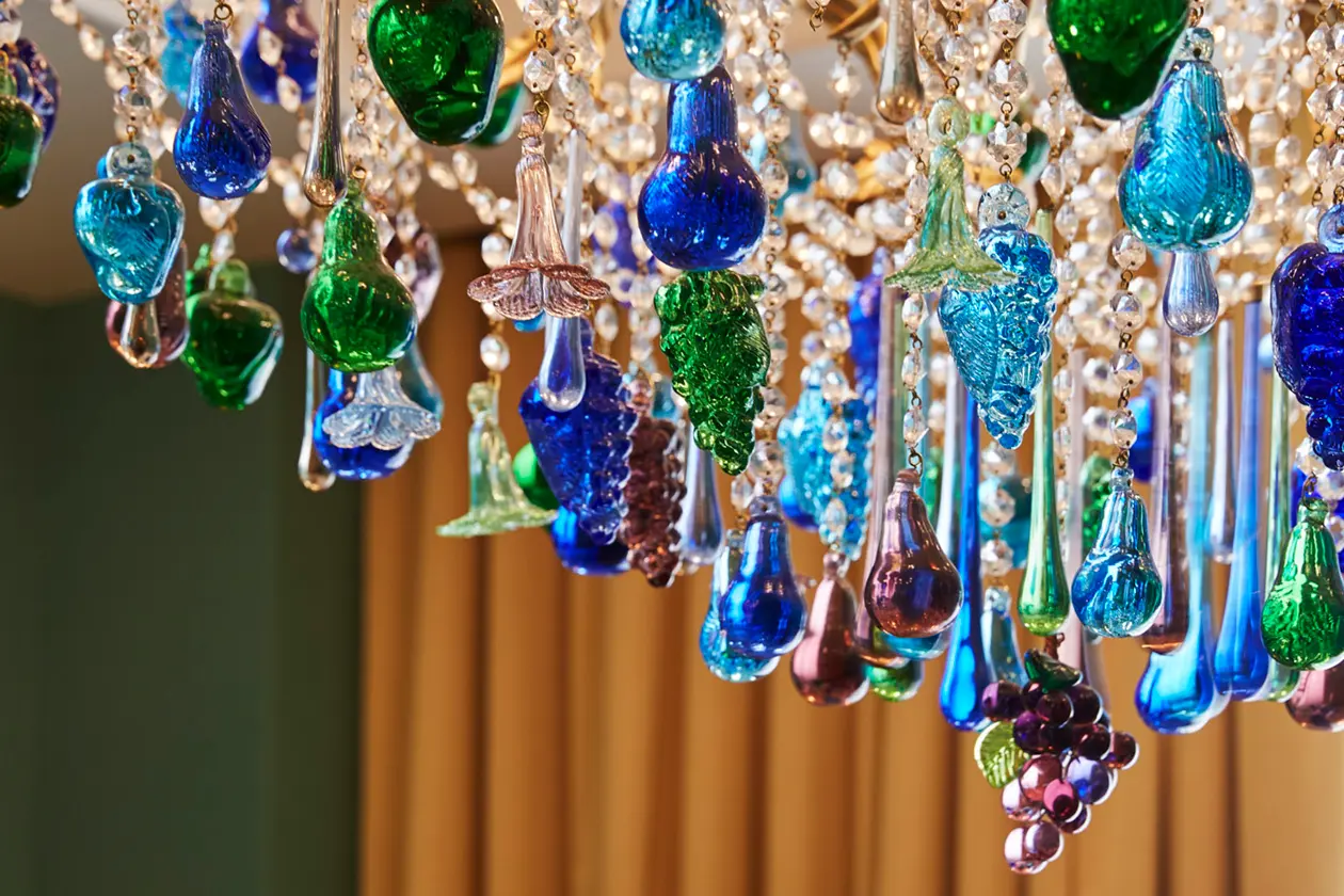 Crystal-adorned chandelier suspended gracefully from the ceiling, enhancing the space with elegance.