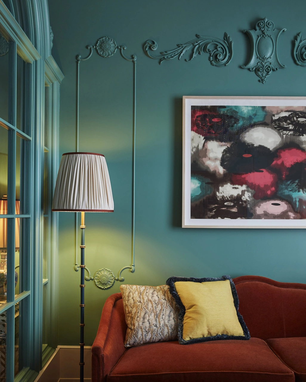 Standing lamp near the couch, and wall adorned with a portrait, creating a harmonious ambiance.