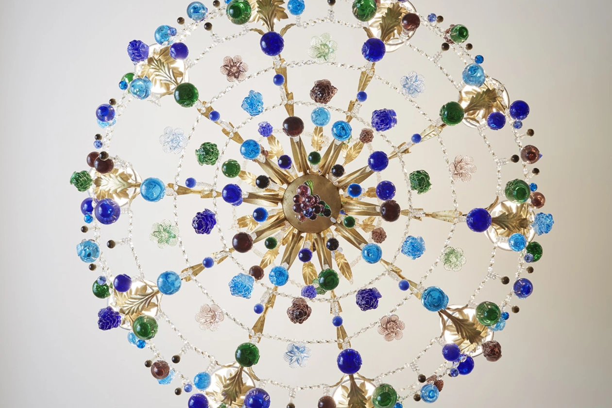 Crystal-adorned chandelier suspended gracefully from the ceiling, enhancing the space with elegance.