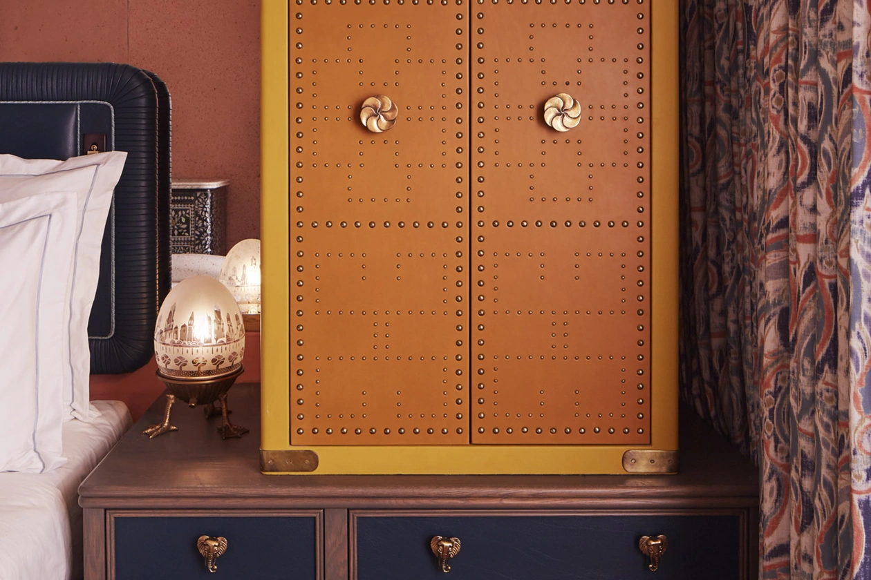 Red and yellow combination safe positioned on the table, accompanied by an oval-shaped night lamp.
