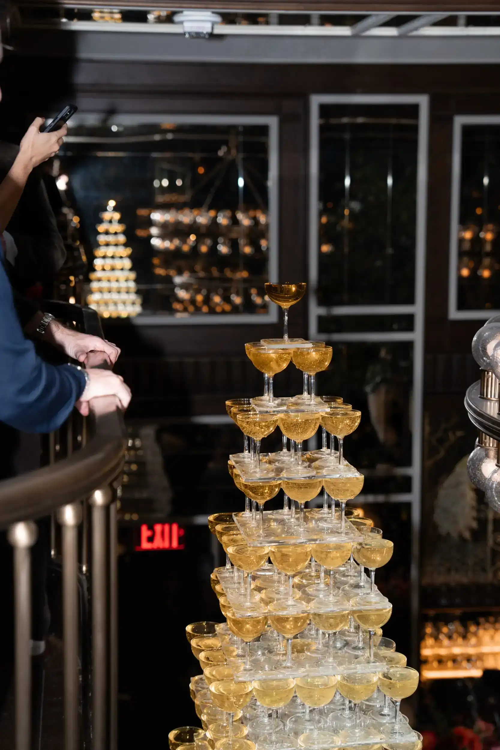 A stunning champagne tower composed of tall glasses, creating an elegant and celebratory centerpiece.