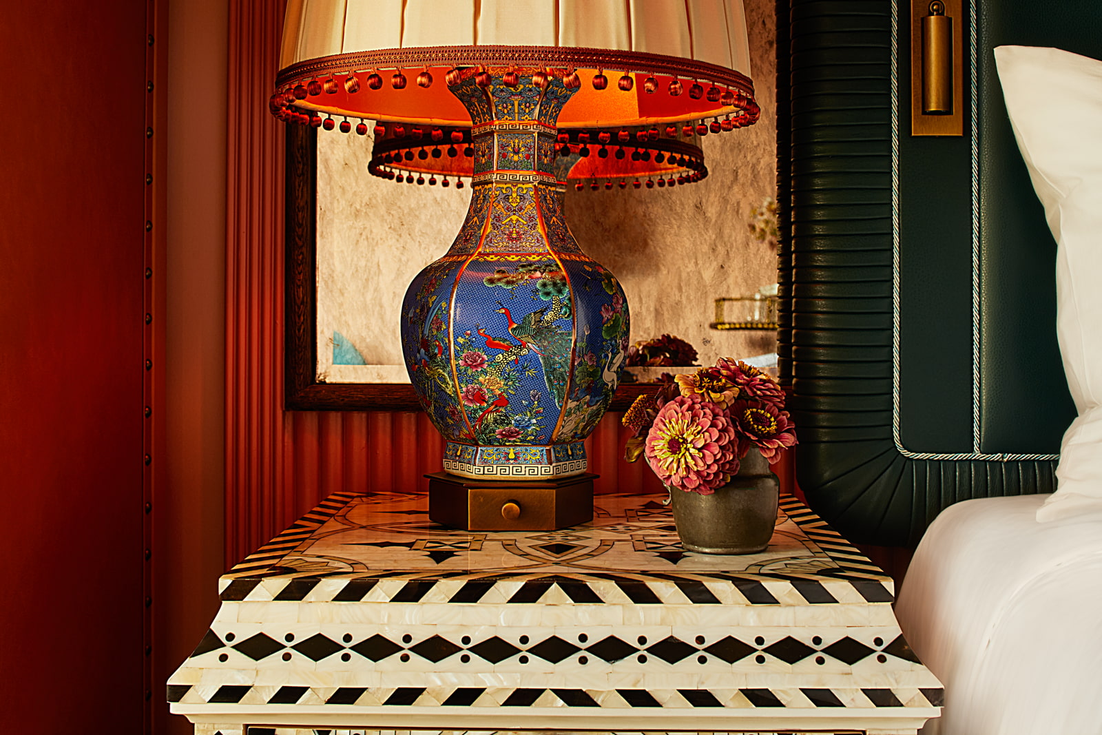 Artisanal night lamp paired with a charming small flower vase on the bedside table.