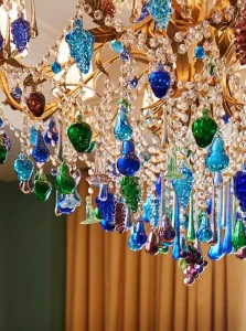 An elegant chandelier with crystal adornments gracefully hangs from the ceiling, elevating the ambiance.