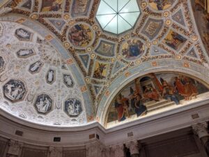 Stunningly decorated ceiling of the museum adorned with remarkable paintings captures attention.