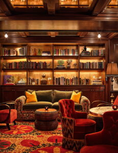 Library room features beautifully arranged sofas and tables, providing comfort for guests.