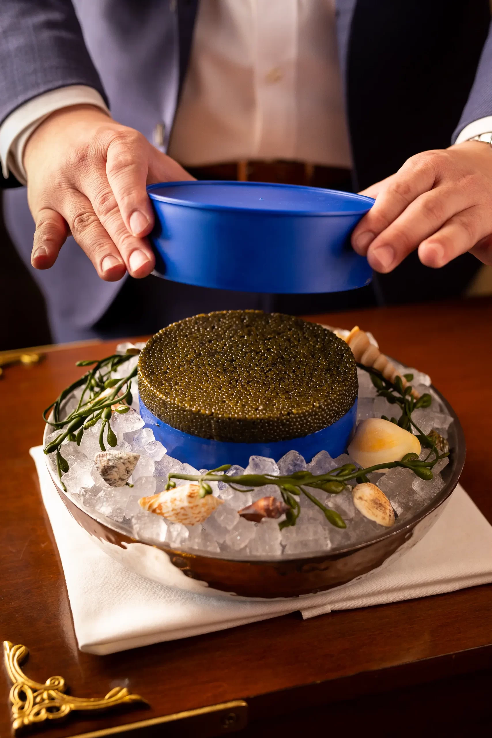 Caviar on ice, elegantly presented in a restaurant setting.