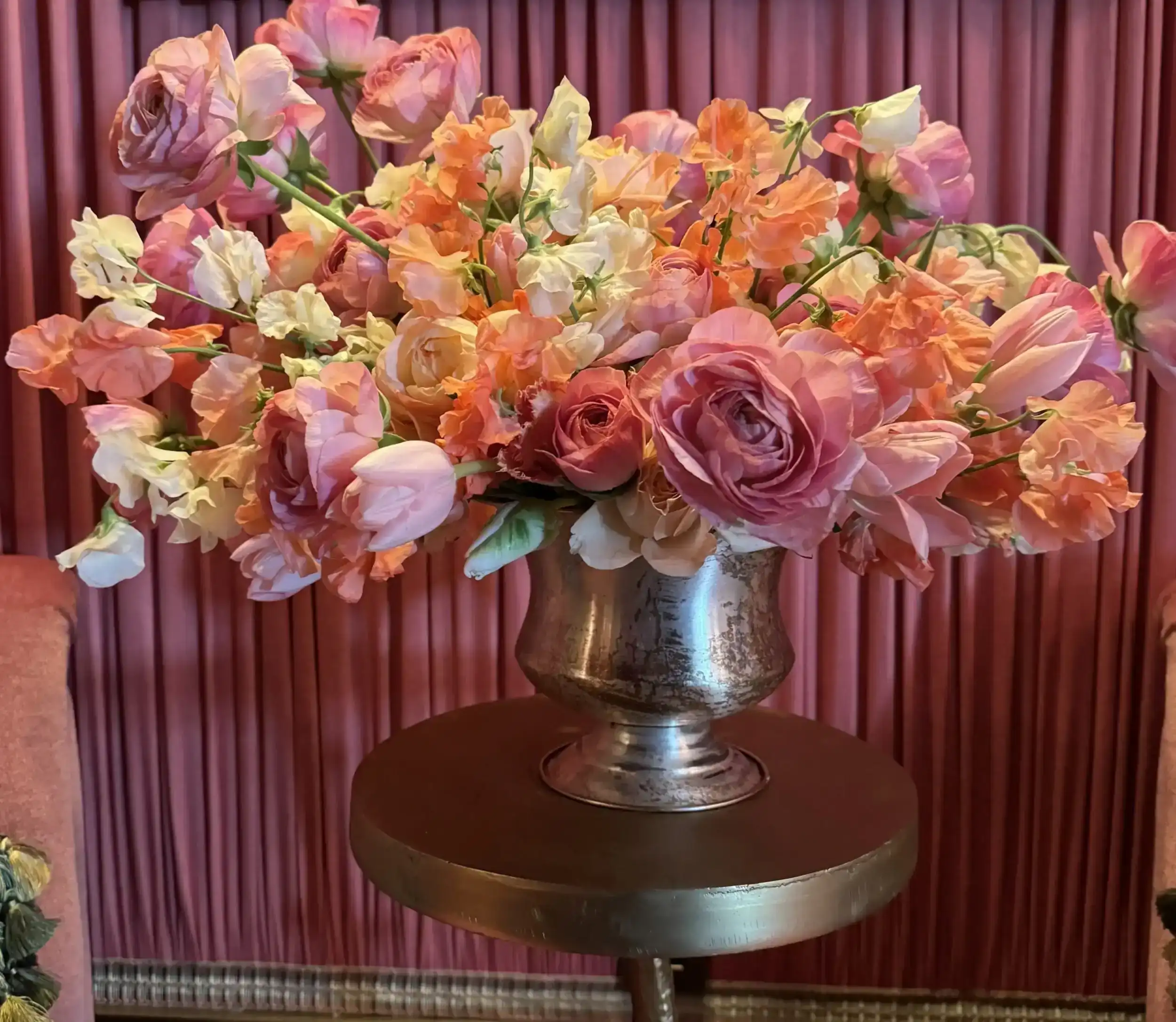 Bunch of flowers featuring roses, placed in flower pots on the table.