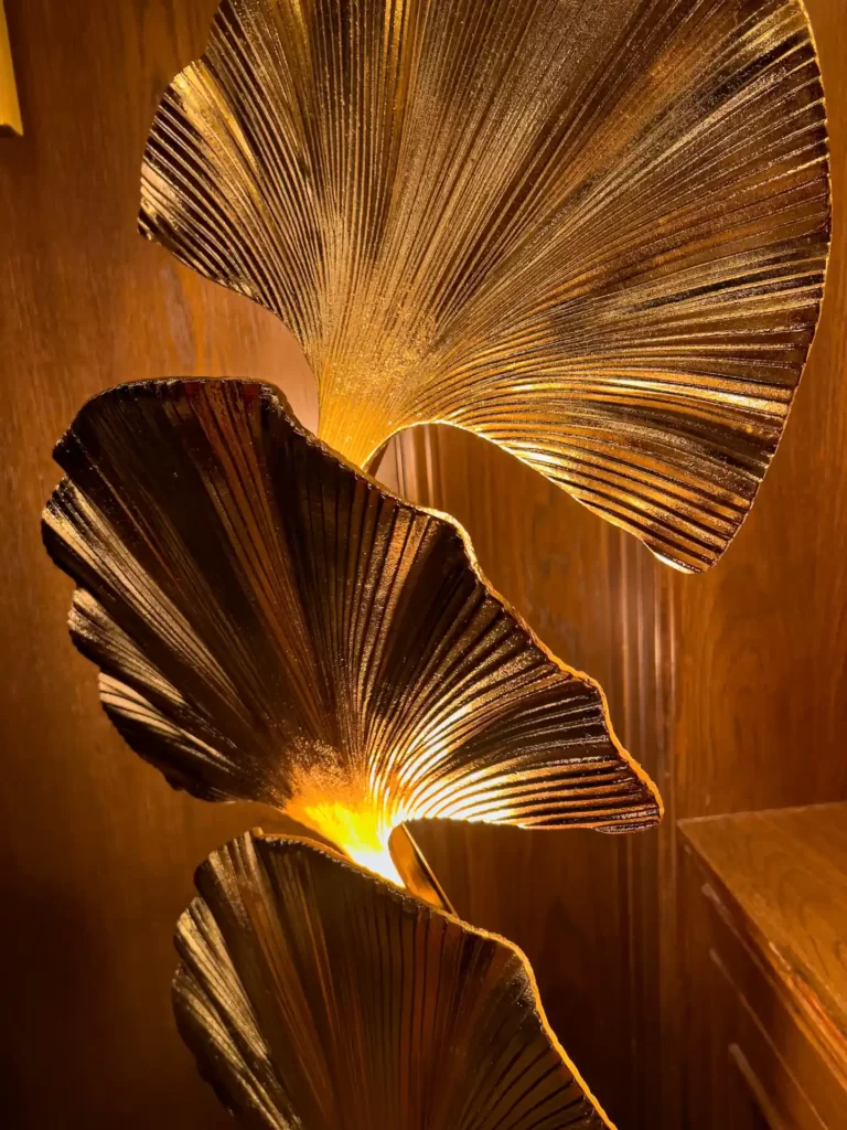 An intricately designed metal leaf is beautifully placed for decorative purposes.