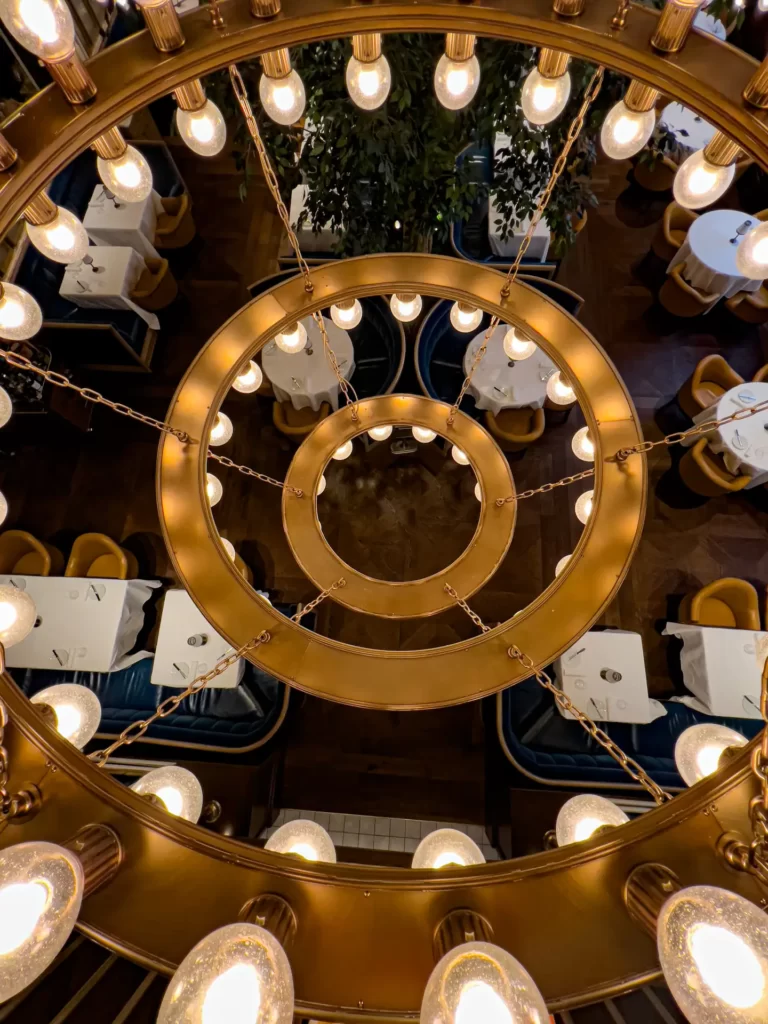 Captured photos of a beautiful chandelier hanging elegantly from the ceiling.