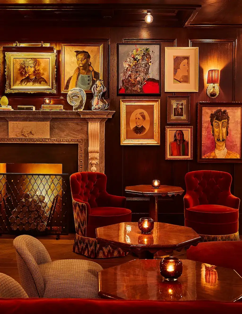 A well-arranged seating area with numerous chairs and tables, and portraits beautifully mounted on the wall.