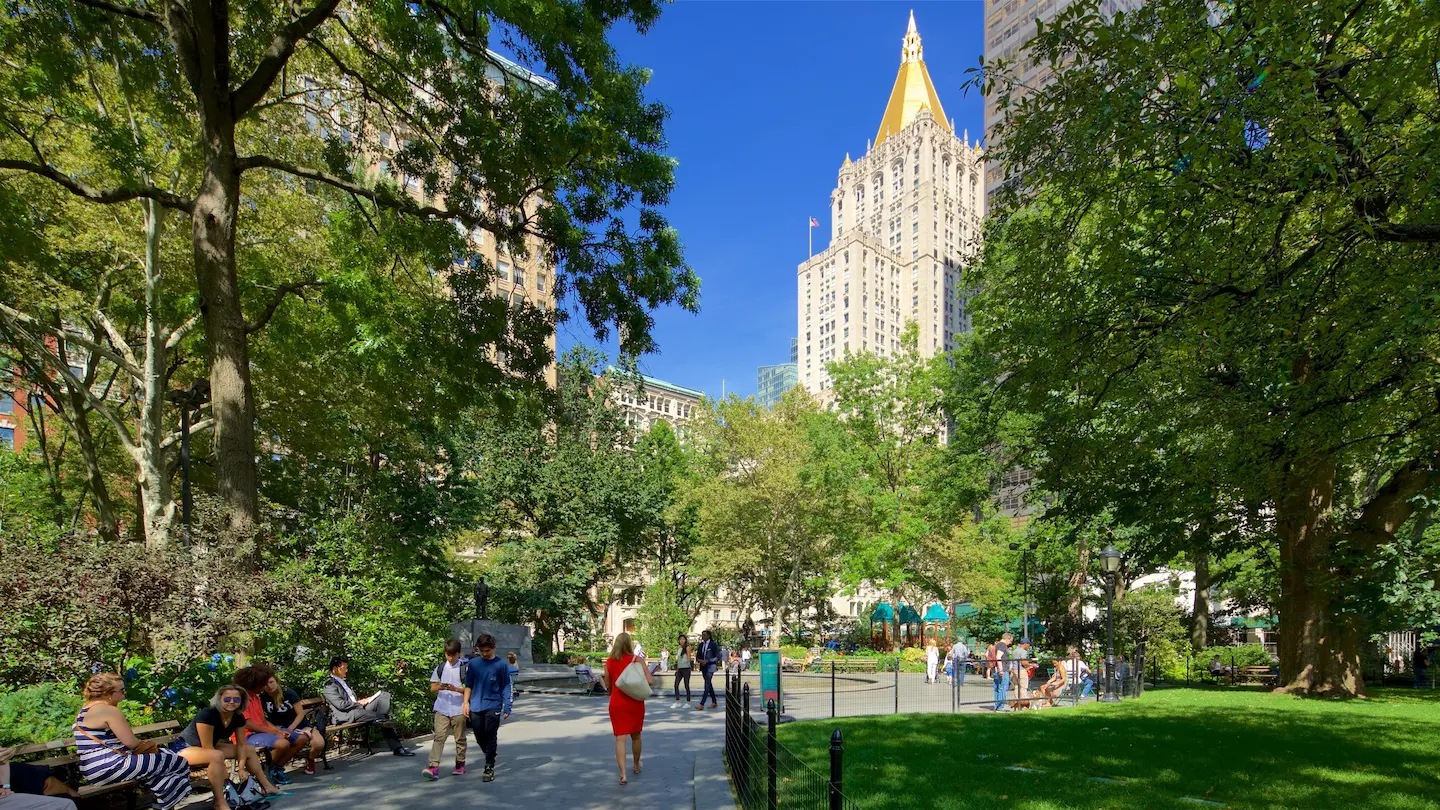 People are enjoying themselves and strolling through Madison Square Park.