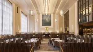 A well-arranged restaurant dining area with small plant pots and decorative lighting lamps.