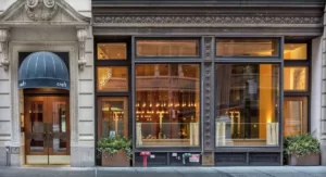 Various types of crafts are visible through the glass window of the craft shop.