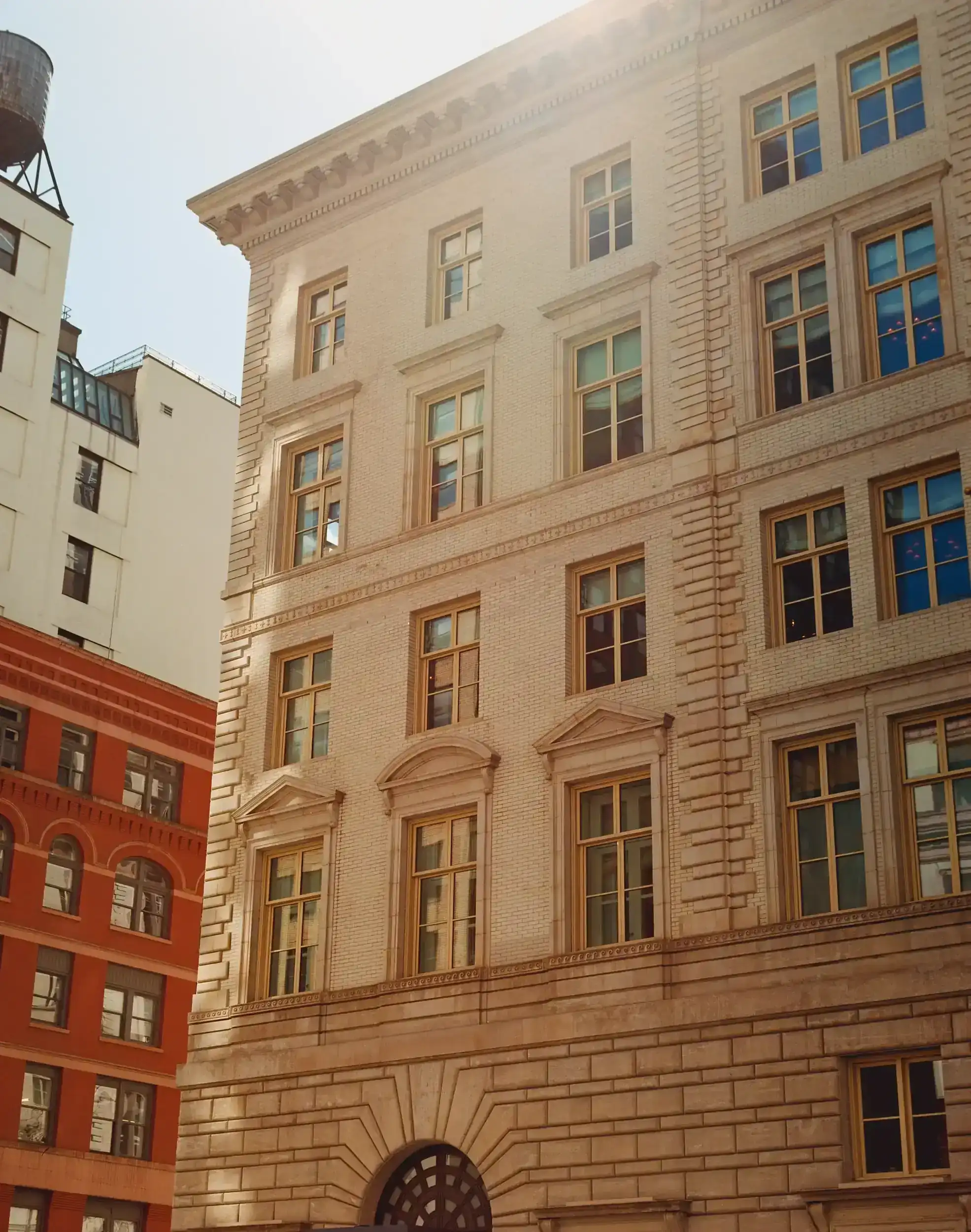 The Fifth Ave Hotel's stunning architectural design glowing with sunlight.