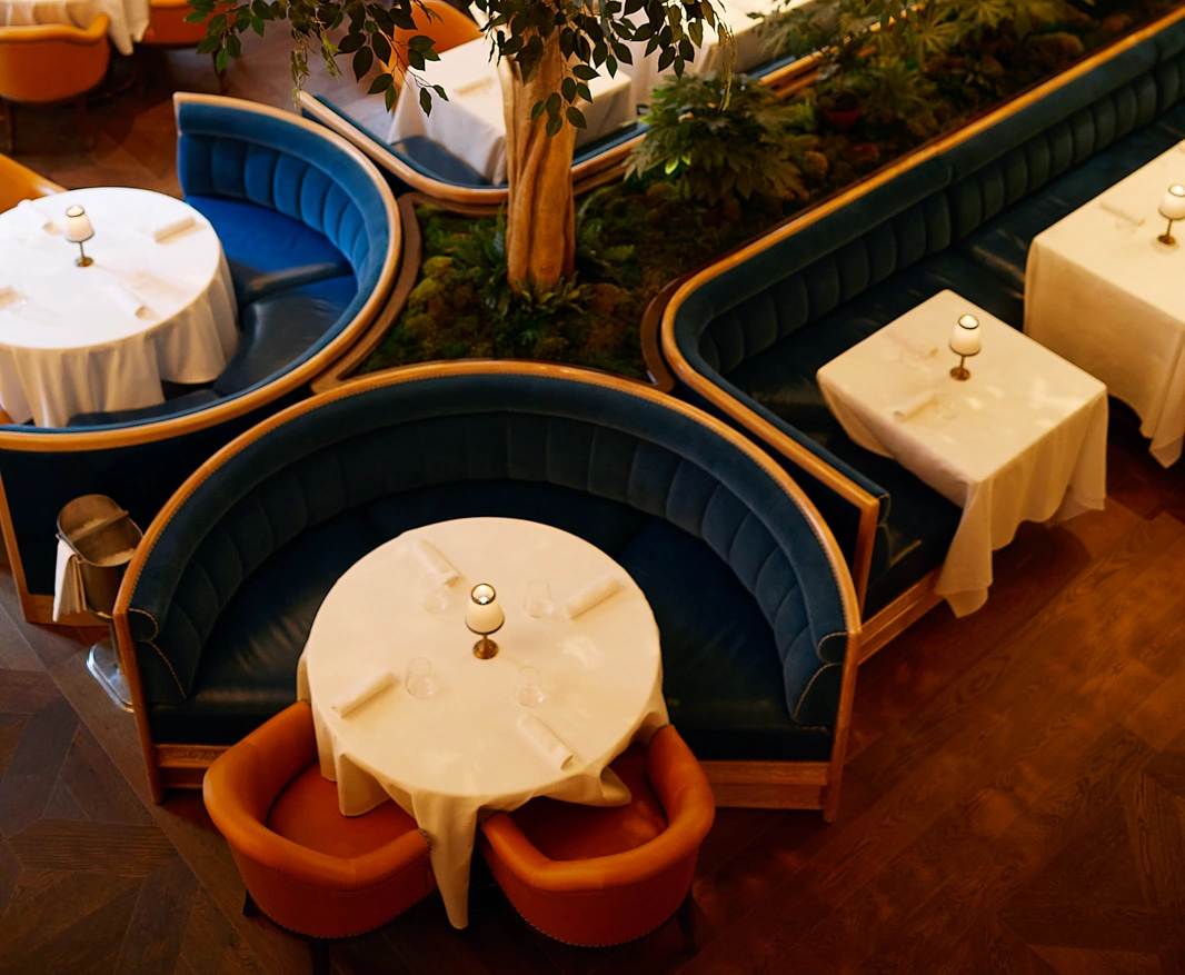 A well-arranged dining area with cozy chairs and a table for customer relaxation.
