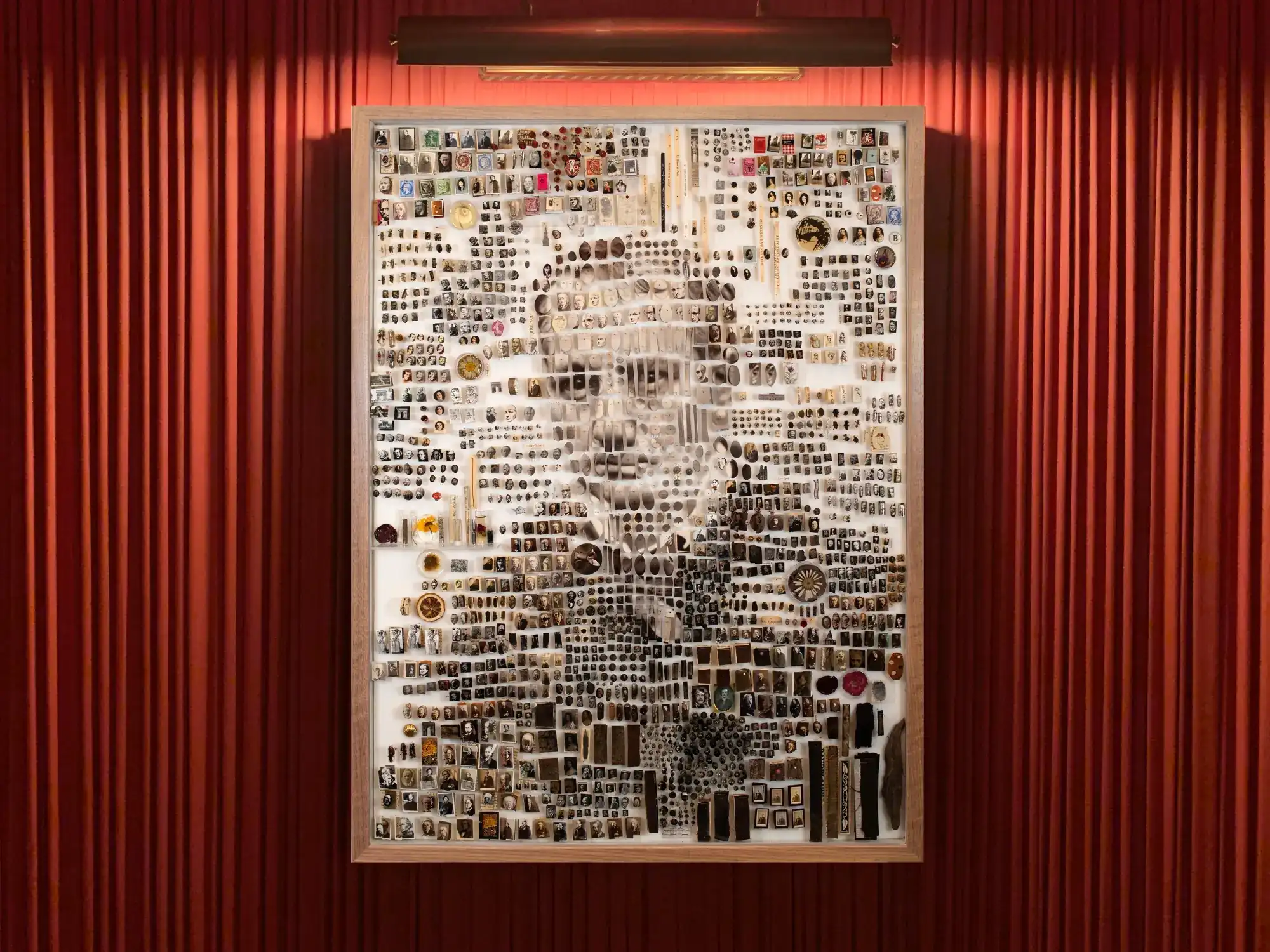 An elegantly designed portrait mounted on a striking red-colored wall.