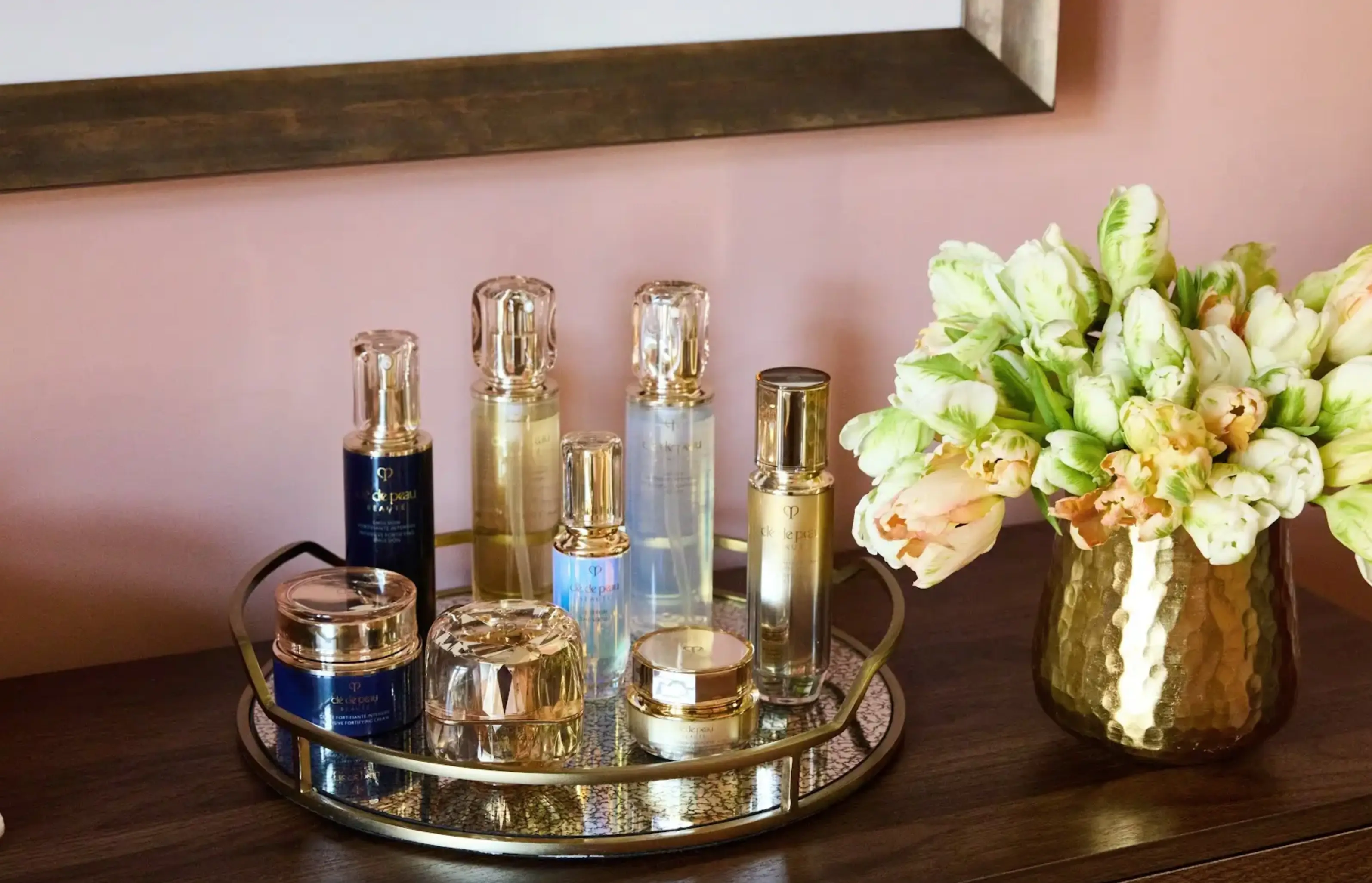 Luxury perfume bottles elegantly arranged on a dresser in a room at The Fifth Avenue hotel, reflecting sophistication.