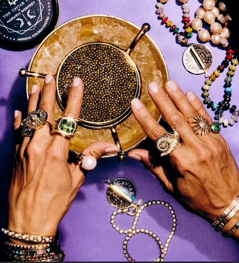 Two hands adorned with an array of stylish jewelry, showcasing intricate designs and sparkling details