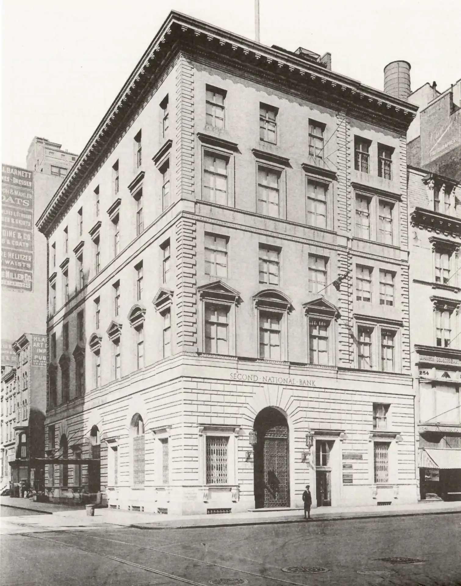 Historic multistory Second National Bank building with arched windows, decorative cornices, stone detailing & corner location