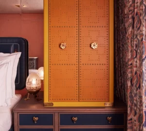 Red and yellow combination safe positioned on the table, accompanied by an oval-shaped night lamp.