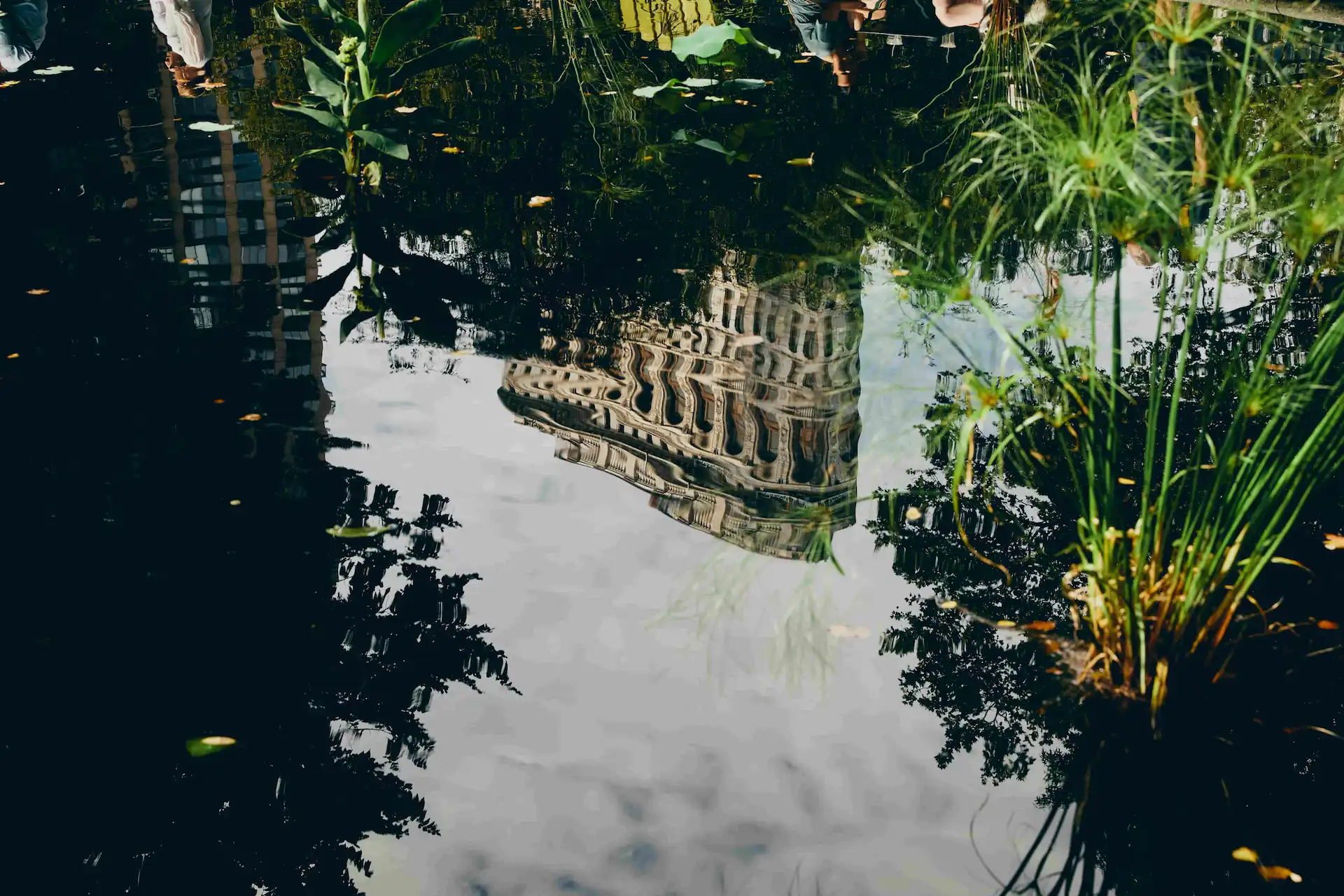 The building's shadow reflects in the water, creating a picturesque scene.