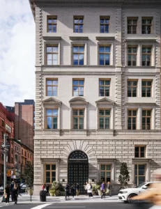 Corner view of classical building with arched doorway, number 250, and pedestrians on 5th Avenue.
