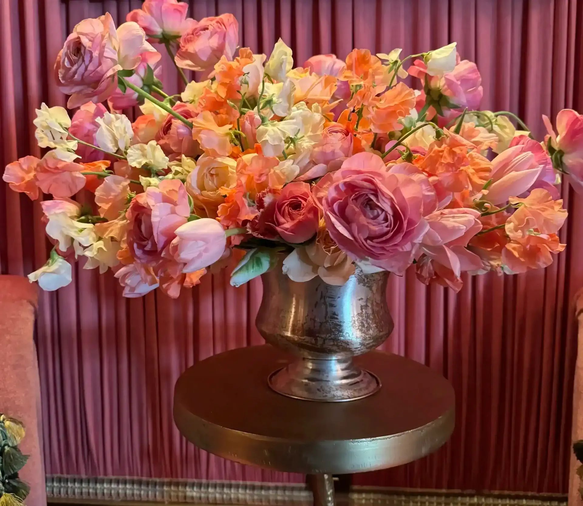 Bunch of flowers featuring roses, placed in flower pots on the table.