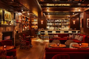 Sofas and tables are neatly arranged near the bar counter for guests' enjoyment.