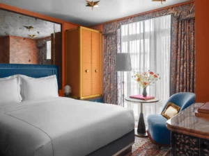 Tastefully organized bedroom with bed, sofa, and table near the window for an inviting ambiance.